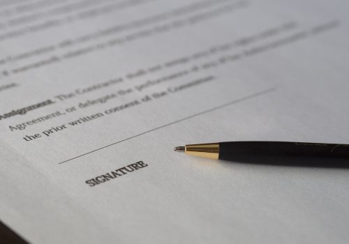 contract with pen laying beside blank line