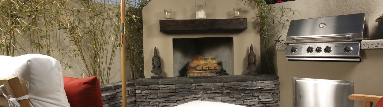 backyard patio with fireplace, lounge chairs and grill