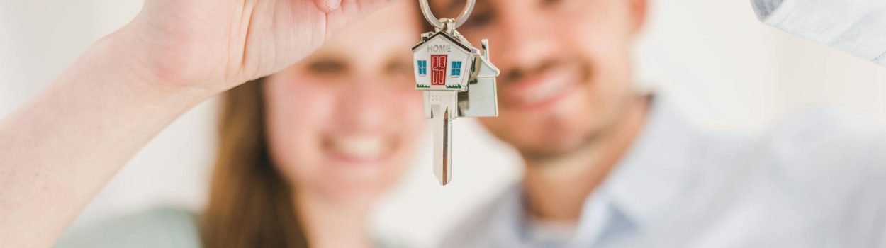 couple holding home key together