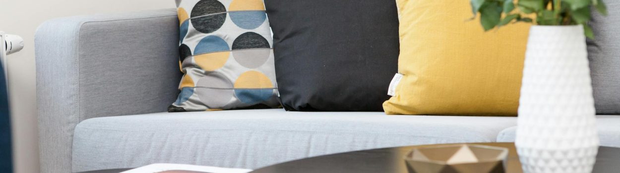 pexels-solliefoto-298842 view of couch beyond coffee tables with pant and magazine